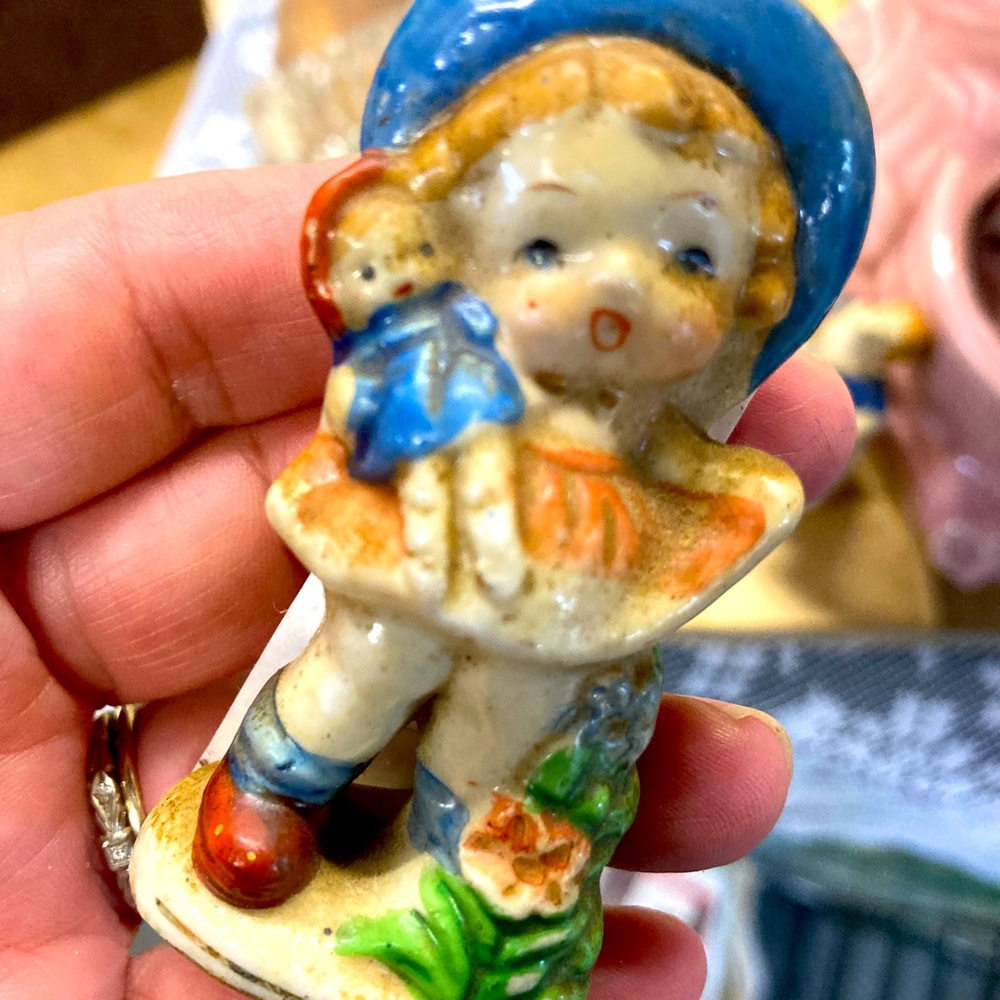 Occupied Japan. Antique bisque wear miniature of girl with doll.